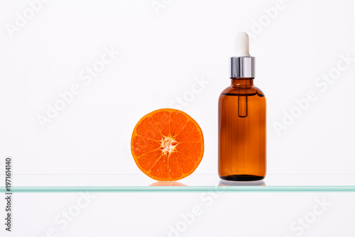 Vitamin C Serum Cosmetic Bottle with Fresh Orange Slice on Minimal White Background with Copy Space, Skincare Anti Aging Concept, Natural Beauty Treatment, Clean Modern Product Shot, Macro, Minimalism