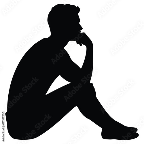 A pensive man sits with his chin resting on his hand deeply lost in thought silhouette