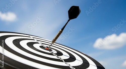 Dartboard with a dart hitting the bullseye on a blue sky background symbolizing success and precision