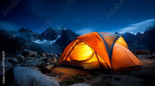 Illuminated Orange Camping Tent in Rocky Terrain