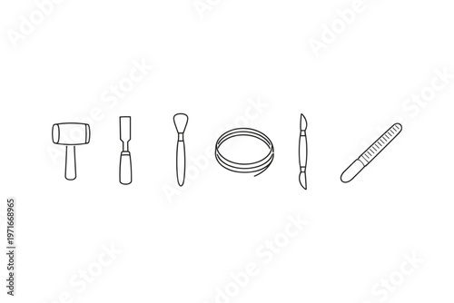 Collection of crafting and sculpting tools arranged in a line on a white background