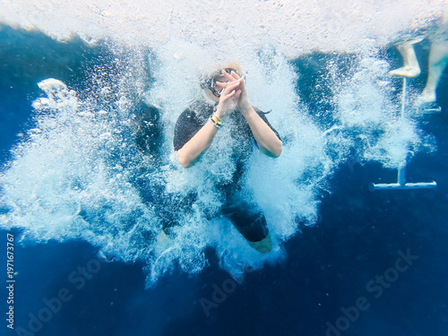 Konstfotografi Young Woman Jumping from a Boat into the Crystal Clear Blue Water of Ras Mohamme