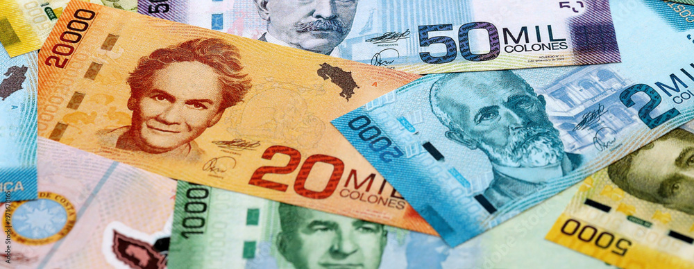 Obraz premium Costa Rican old colon money banknotes pile on table. Costa Rica bills of CRC currency close up