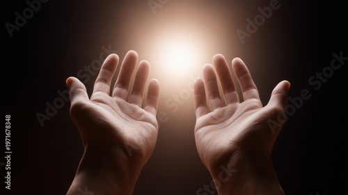 Human hands reaching toward a soft glowing light, conveying hope, openness, and emotional warmth.