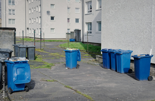 Wheelie bins in row for refuge collection left outdoors in council estate