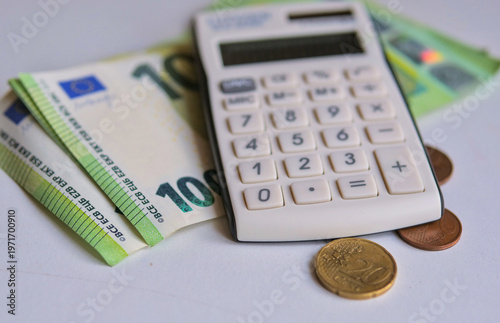 Fotografie Calculator with Euro Banknotes and Coins on Grey Surface — Personal Finance Budg