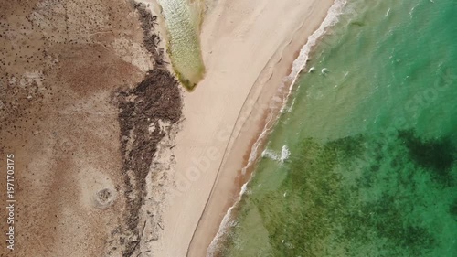 Panoramic aerial video of Socotra Island's rugged coastline, where desert cliffs meet the turquoise ocean, perfect for travel and adventure footage