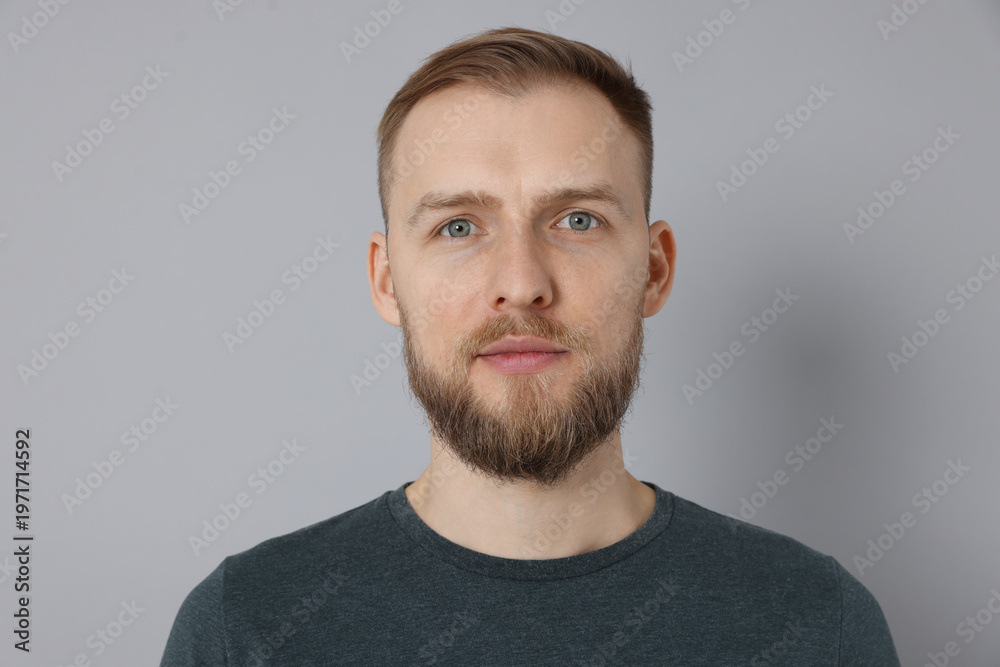 Fototapeta premium Portrait of handsome man on light grey background