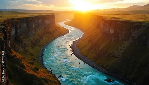 Wide river winds through grand canyon. Steep cliffs rise along water edges. Sun sets creating warm golden hour light. Beautiful natural scene.