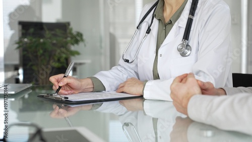Valokuva Doctor woman discussing medical information with patient during a healthcare consultation in a professional clinic office, close up
