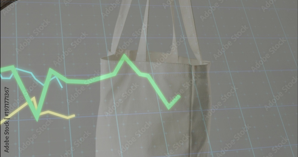 Fototapeta premium Hanging seamed beige tote with straps in studio, overlaying green-cyan-yellow line graphs on grid