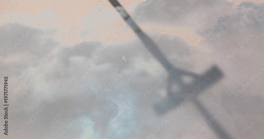 Fototapeta premium Crossing blurred diagonal shape stretching through layered clouds at dawn, with faint sun