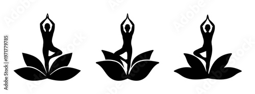 Three black silhouettes of people practicing yoga on lotus flowers