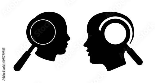 Two black silhouette heads with magnifying glasses on them