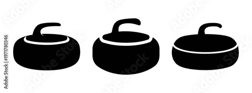Three black curling stones with handles on top