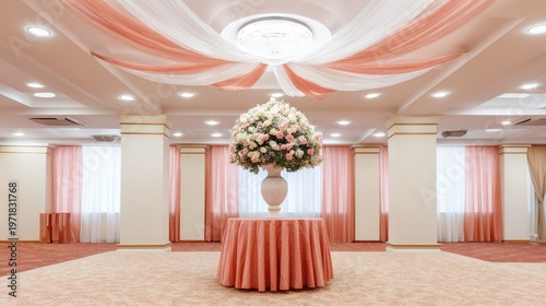 Elegant interior space prepared for a formal celebration with floral arrangements and draped fabric decorations