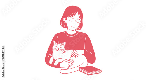 Young woman cradling pet cat beside book