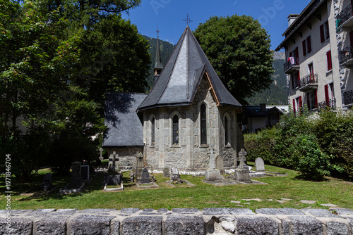 Chamonix-Mont-Blanc, Haute Savoie, France - August 09th, 2025: Back of the Protestant church with tombs in the garden.