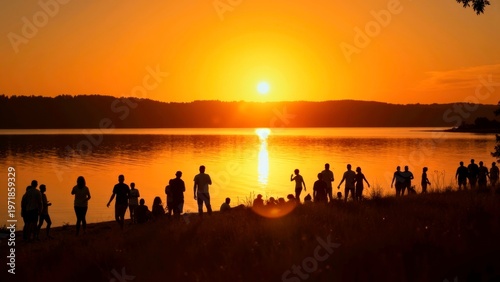Silhouette of People Watching Golden Sunset Over Lake