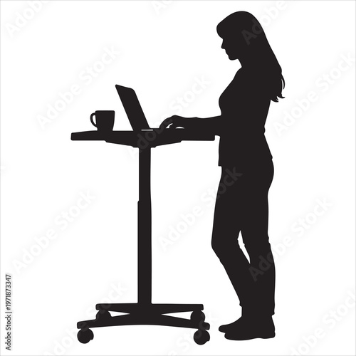 A woman standing at a desk with a laptop and coffee
