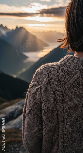 Woman looking at mountain landscape sunset.