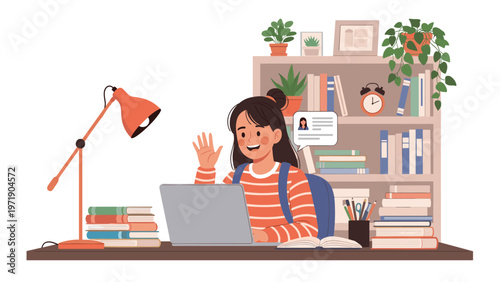 Young girl sits at her desk full of books and a lamp waving at her laptop screen while participating in an online video call class.
