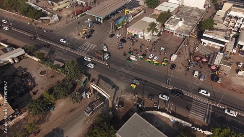 High Angle View of Busy T-Junction Traffic with Auto Rickshaws and Petrol Pump Station in India.
