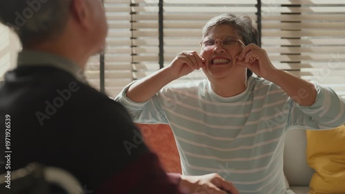 Old Asian senior couple showing love and support, woman holding hands of sick man in wheelchair, caregiving, encouragement, bonding and compassion, uplifting family moment, strength, hope and resilien