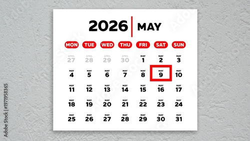 The date May 9th marked with a red cursor on a wall calendar 2026