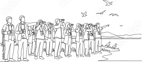 people standing by the ocean looking out at birds flying