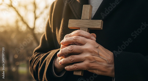 Wallpaper Mural Close Up of Hands Holding a Wooden Cross Outdoors in Golden Sunlight Torontodigital.ca