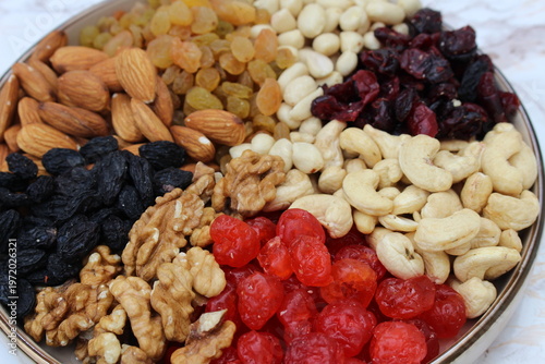 a mixture of nuts and dried fruits on the table in a plate
