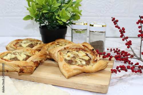 There are puff pastry pies on the table