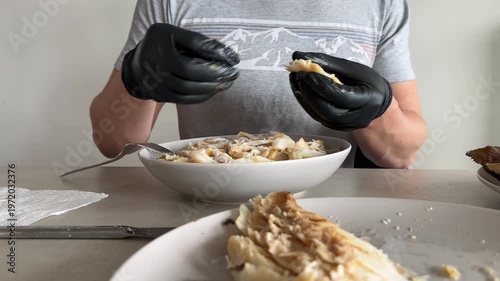 Midsection of man cleaning the bones of cooked cod