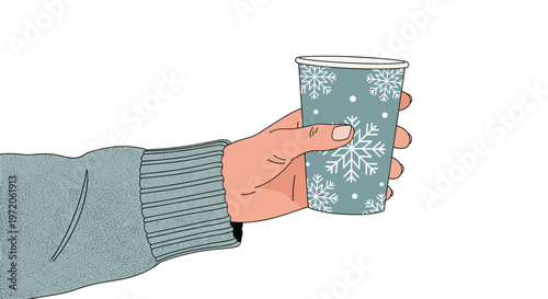 Hand in a grey knitted sweater holding a festive blue paper coffee cup decorated with white snowflakes patterns.