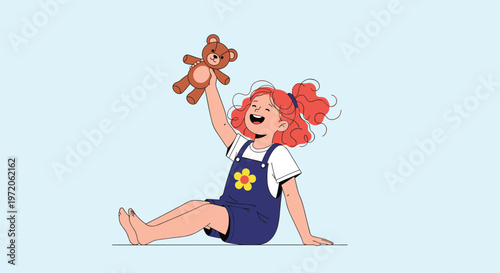 Joyful little girl with curly red hair sitting and playing happily with her favorite brown teddy bear toy on blue backdrop.