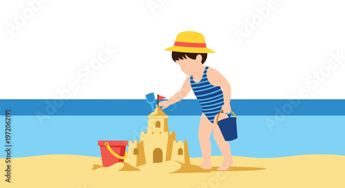 Little boy wearing a straw hat and swimsuit building a detailed sandcastle with bucket and spade on a sunny beach near sea.