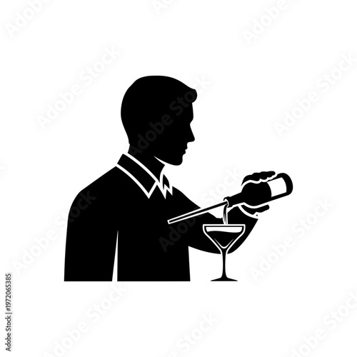 A bartender pouring a drink into a martini glass in a sophisticated setting