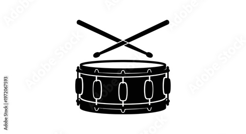 Black snare drum with drumsticks.