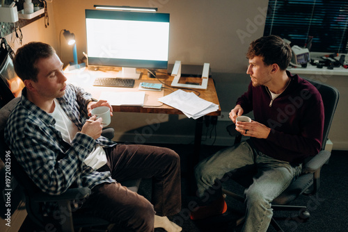 Картината върху платно Two friends enjoy warm cups of coffee while engaged in a deep conversation