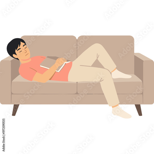 Man reclines on brown couch reading book with legs crossed