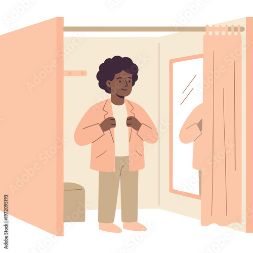 A woman is trying on a pink jacket in a fitting room with a mirror.