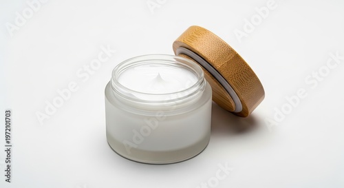 Luxury Frosted Glass Cosmetic Jar with Bamboo Lid and White Moisturizing Face Cream Isolated on White Background