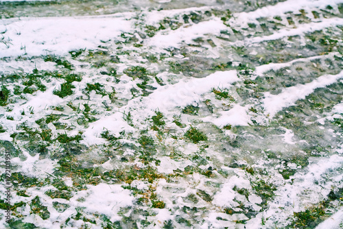 Foto Melting snow covering ground with green grass