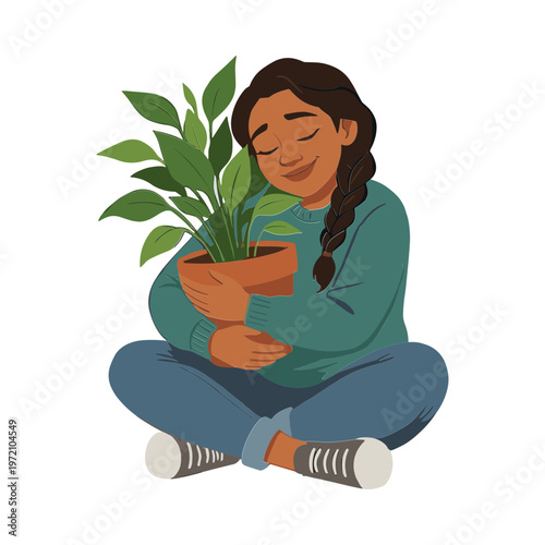 A woman happily holding a potted plant while sitting cross-legged indoors