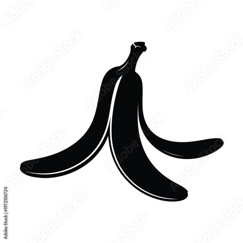 A black silhouette of a peeled banana lying on a white surface