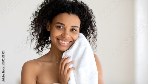 Smiling woman holding towel after skincare routine, fresh clean skin and natural beauty