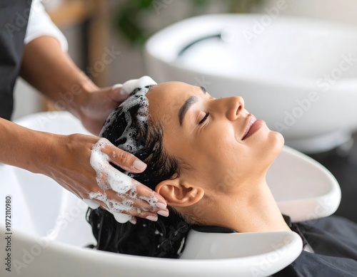 Woman enjoying hair wash at salon sink, relaxing shampoo treatment close-up