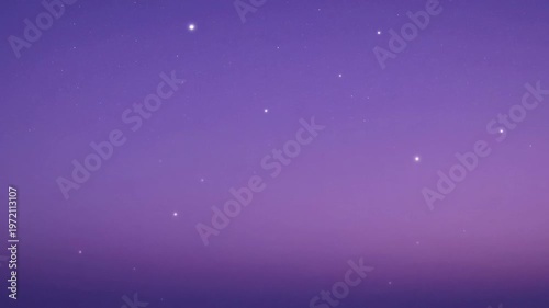 The video captures a serene night sky filled with numerous stars scattered across a gradient background of purple and blue hues