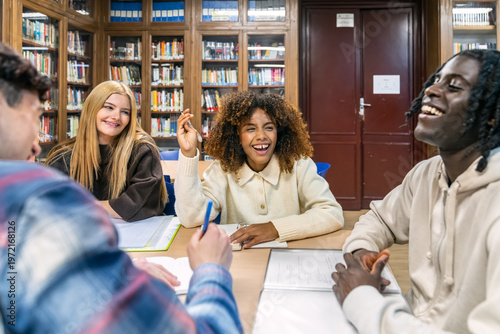 Diverse group of college students collaborating on a project in a library, sharing ideas and enjoying teamwork